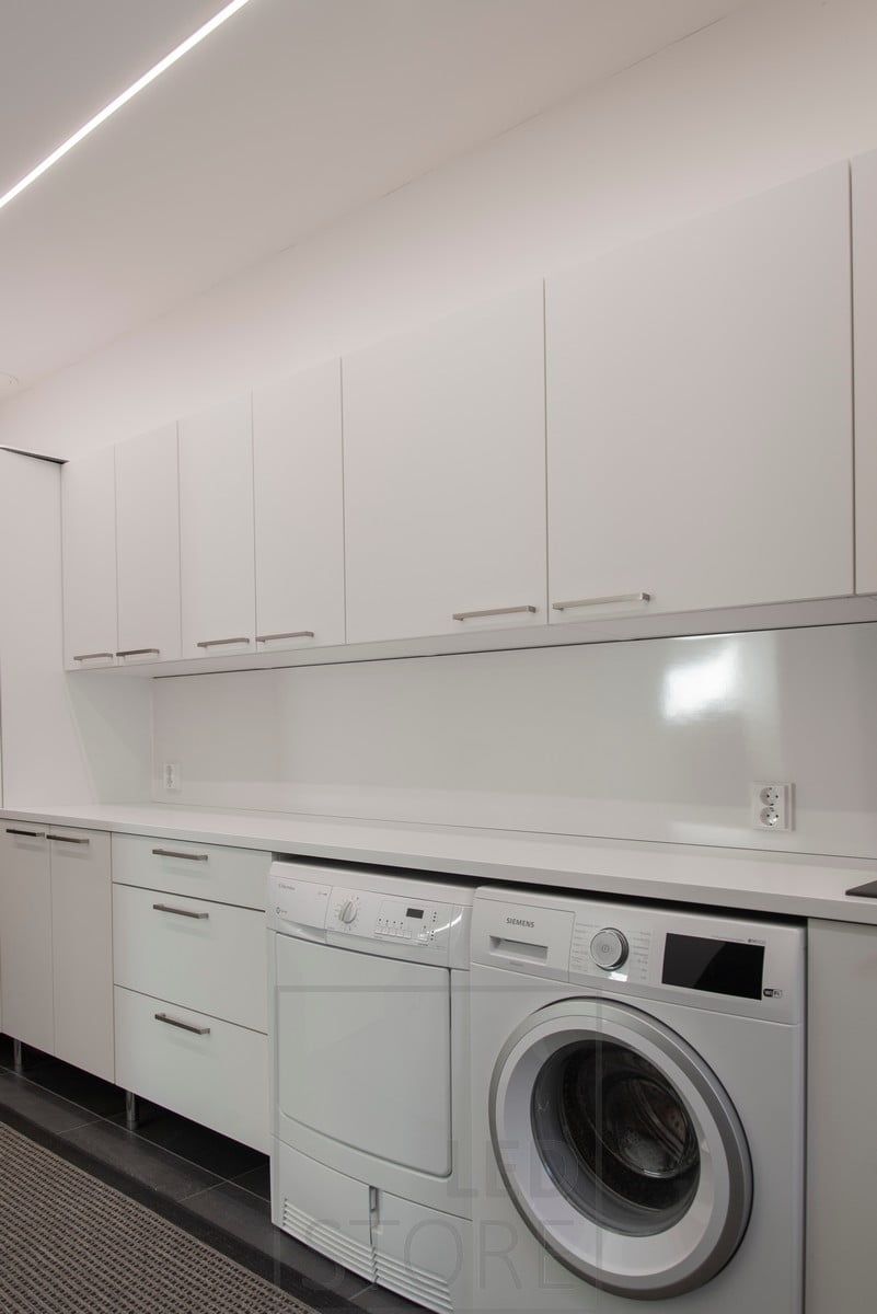 Recessed LED strips in the ceiling in the flush-mounted profiles illuminating the utility room. Ledstore.fi