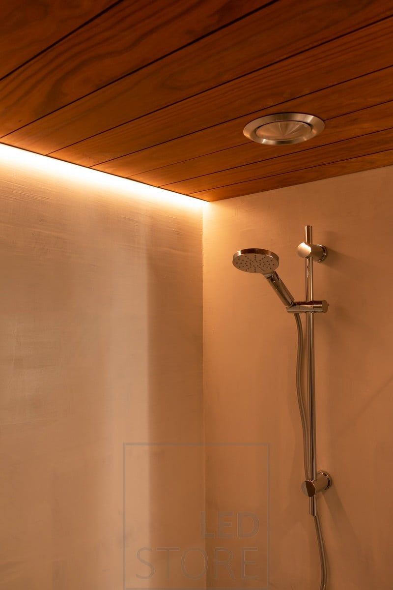 In a corner profile flush with the ceiling, a led strip illuminates the shower. Ledstore.fi