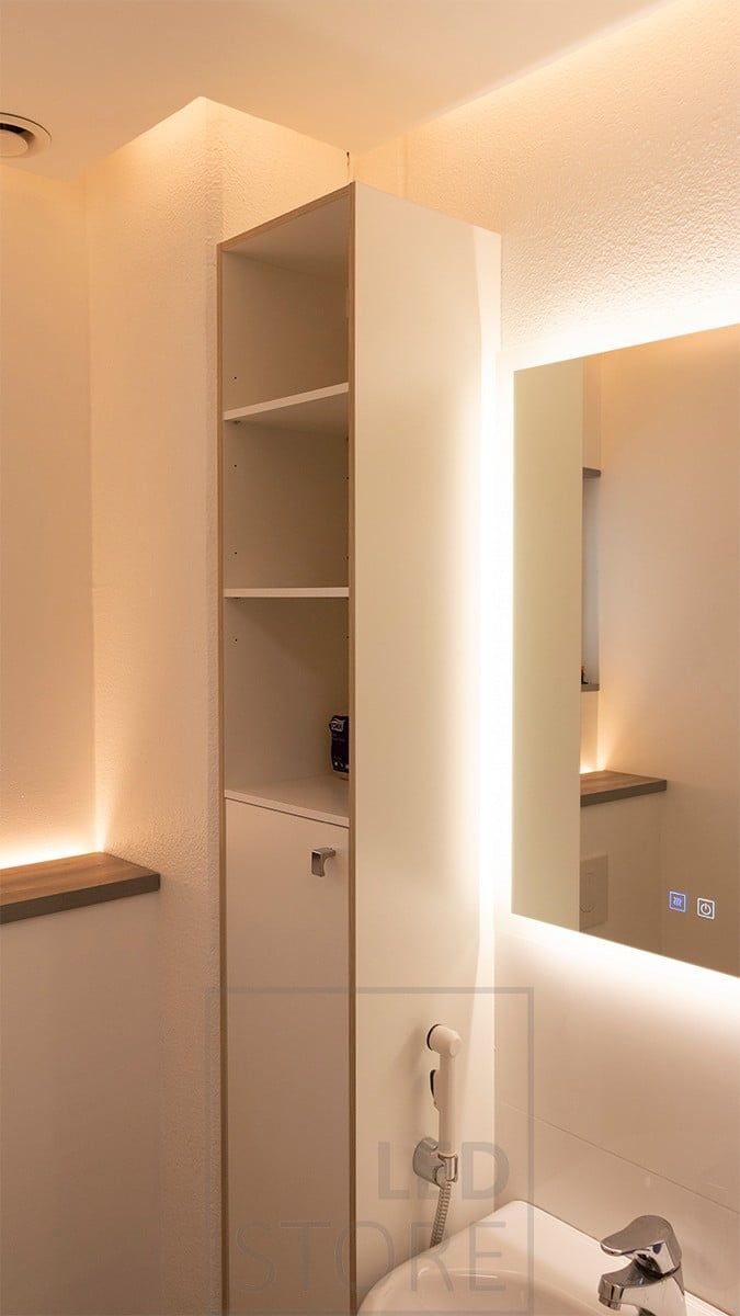 Indirect light in the bathroom. A light mirror combined with indirect light from the ceiling and an upward LED strip behind the toilet enclosure. Ledstore.fi