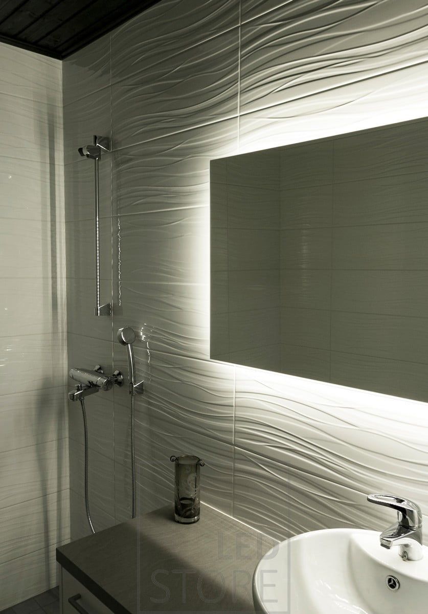 A Led strip mounted behind a mirror brings out the pattern in a bathroom. Ledstore.fi