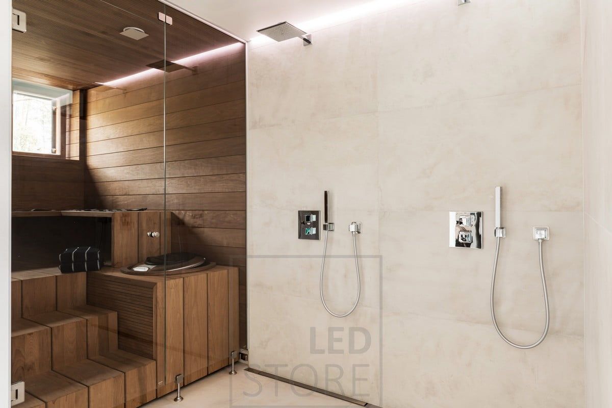 Indirect light behind the shower in the bathroom. Led strip in waterproof profile between ceiling and wall in a groove. Ledstore.fi