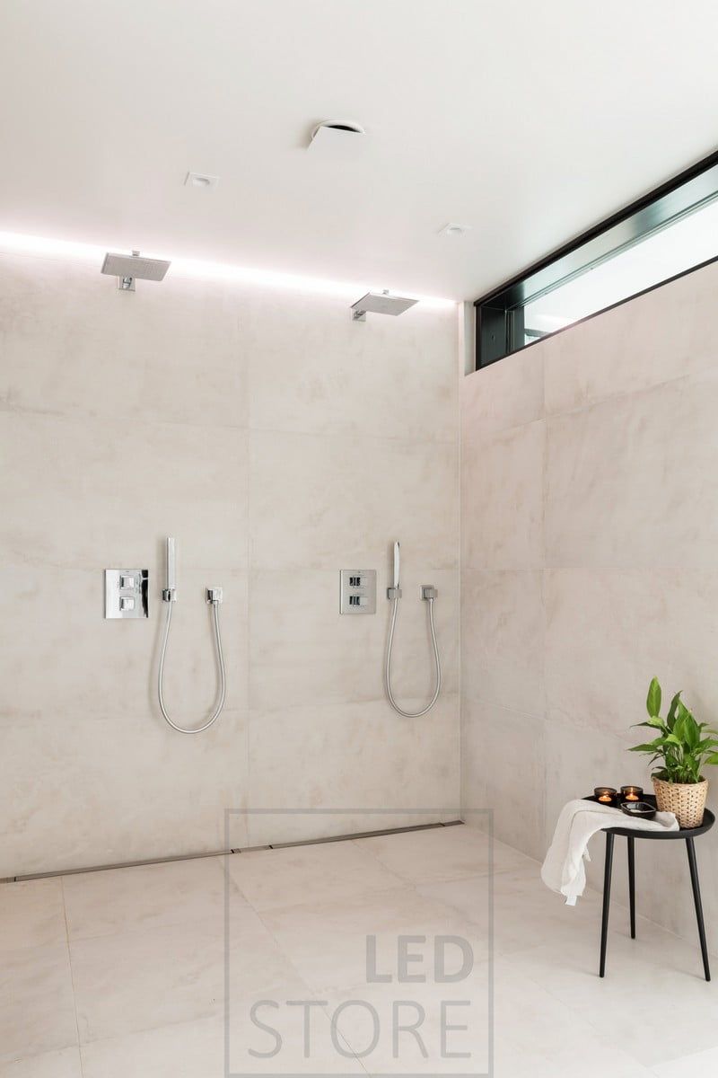 Indirect light behind the shower. Led strip in a groove between ceiling and wall. Ledstore.fi