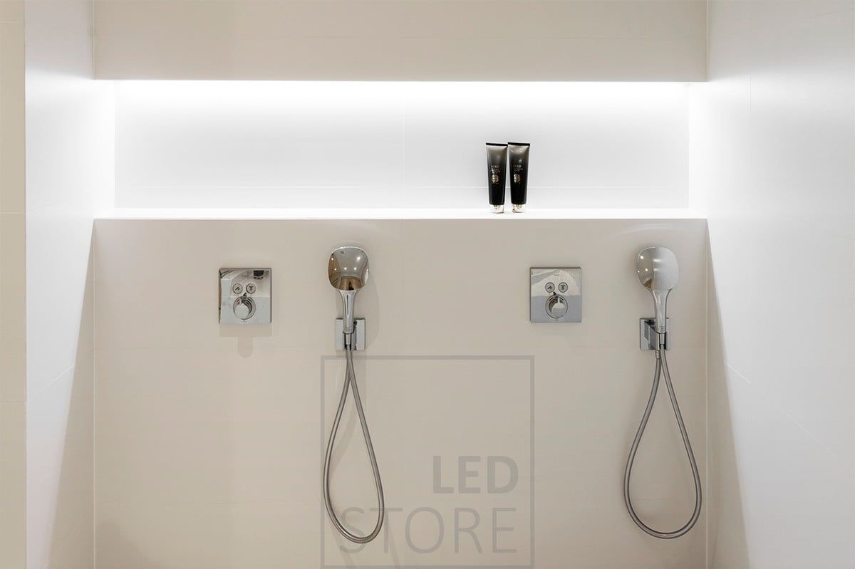 Shampoo shelf in the bathroom, in the upper corner of the shelf illuminated by a led strip. Ledstore.fi