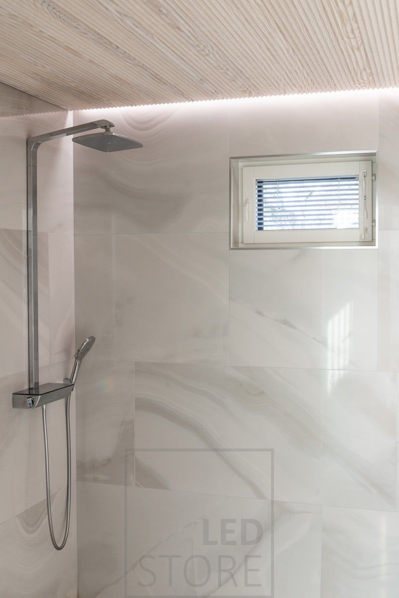 Led strip between the ceiling and the wall indirectly illuminating the shower, creating a spa atmosphere. Ledstore.fi