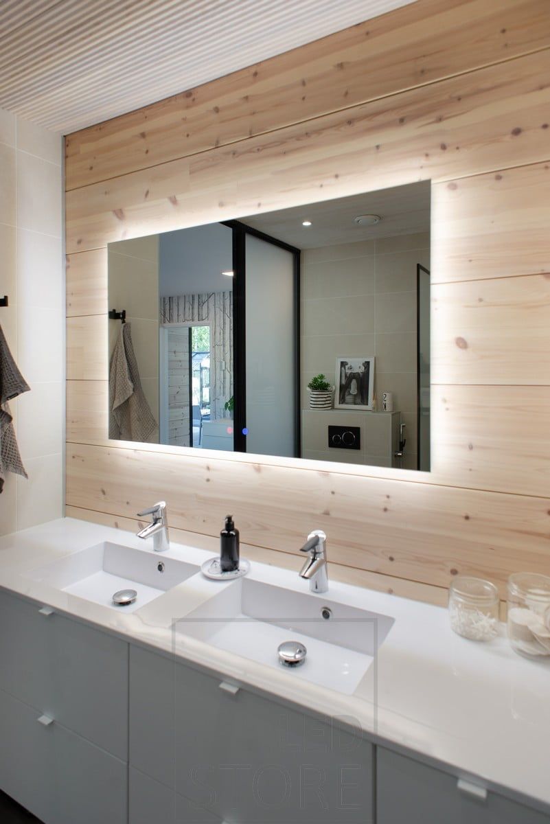 In the bathroom, light from behind a 1200mmx750mm light mirror highlights the beautiful wood panelling and illuminates the level. Ledstore.fi