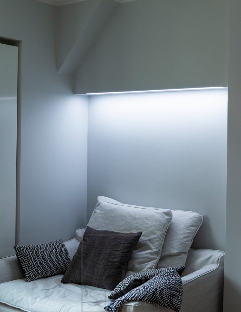 In the bedroom, colour temperature adjustable mood lighting behind the bed, mounted on the base of the wardrobe. In the picture, the colour temperature is set to a cold tone. Ledstore.fi