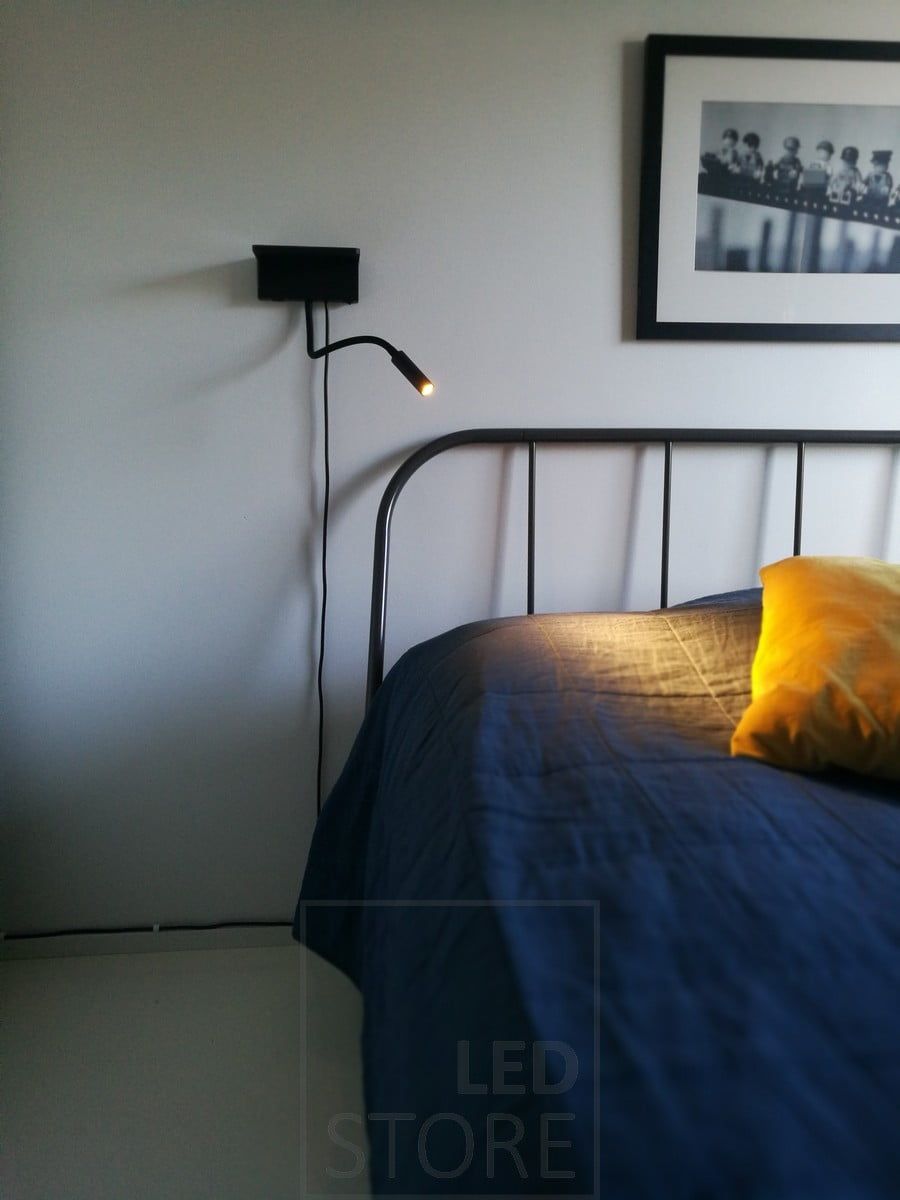 BLADE wall lamp next to the bed. It functions as a reading light and has both wired and wireless charging for your phone. Ledstore.fi