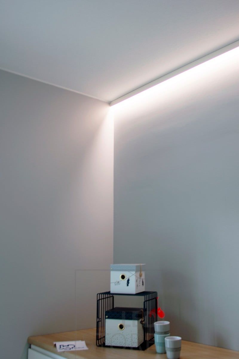 Behind the led strip, indirectly illuminating the bedroom with mood lighting. Ledstore.fi