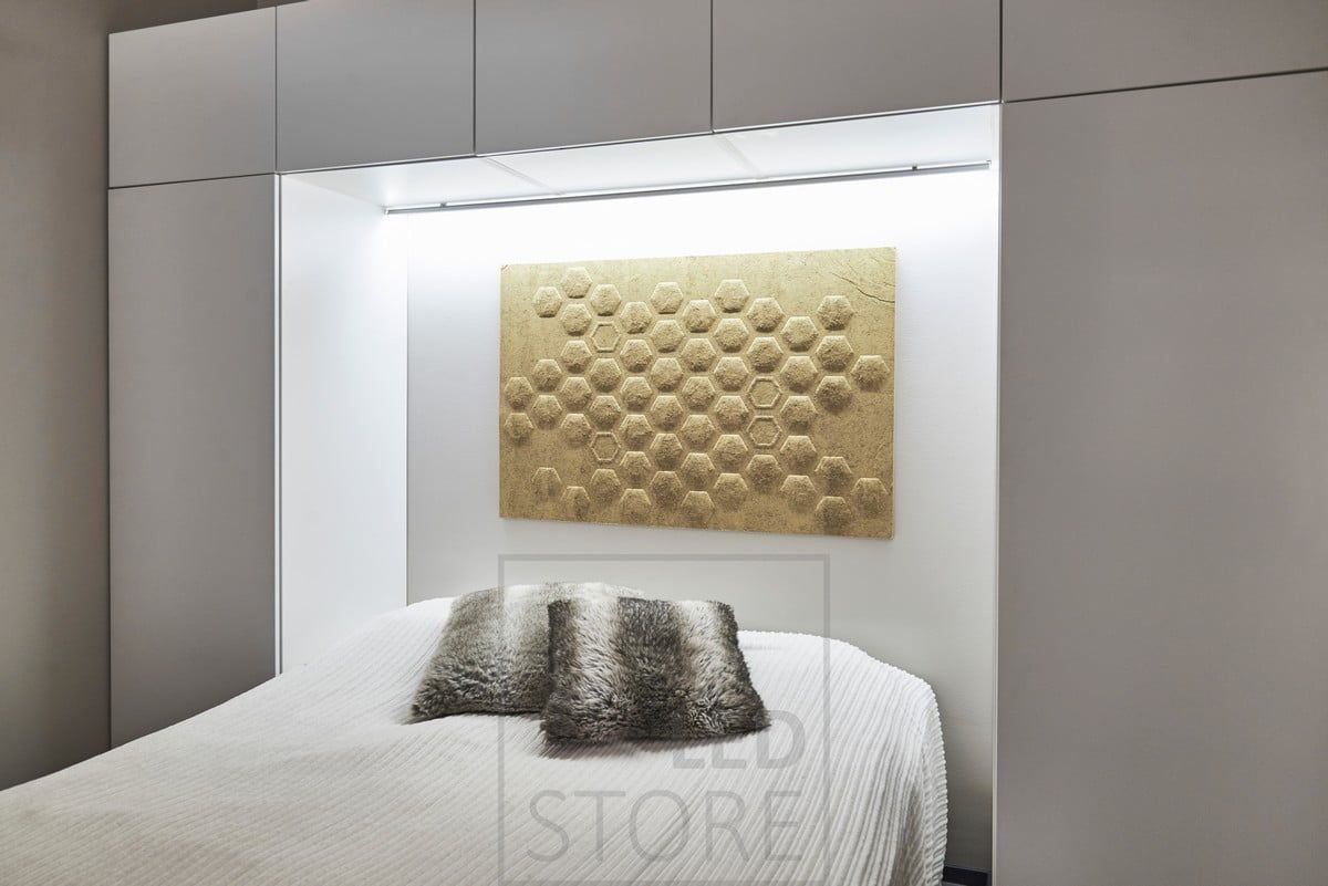 Bed headboard with LED strip mounted in the upper corner of the cabinets. The led strip illuminates the bedroom with atmospheric light. Ledstore.fi