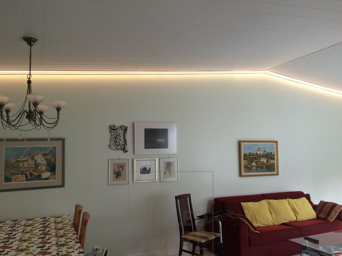 A LED strip along the edges of the space illuminates the living room with atmospheric light. Ledstore.fi