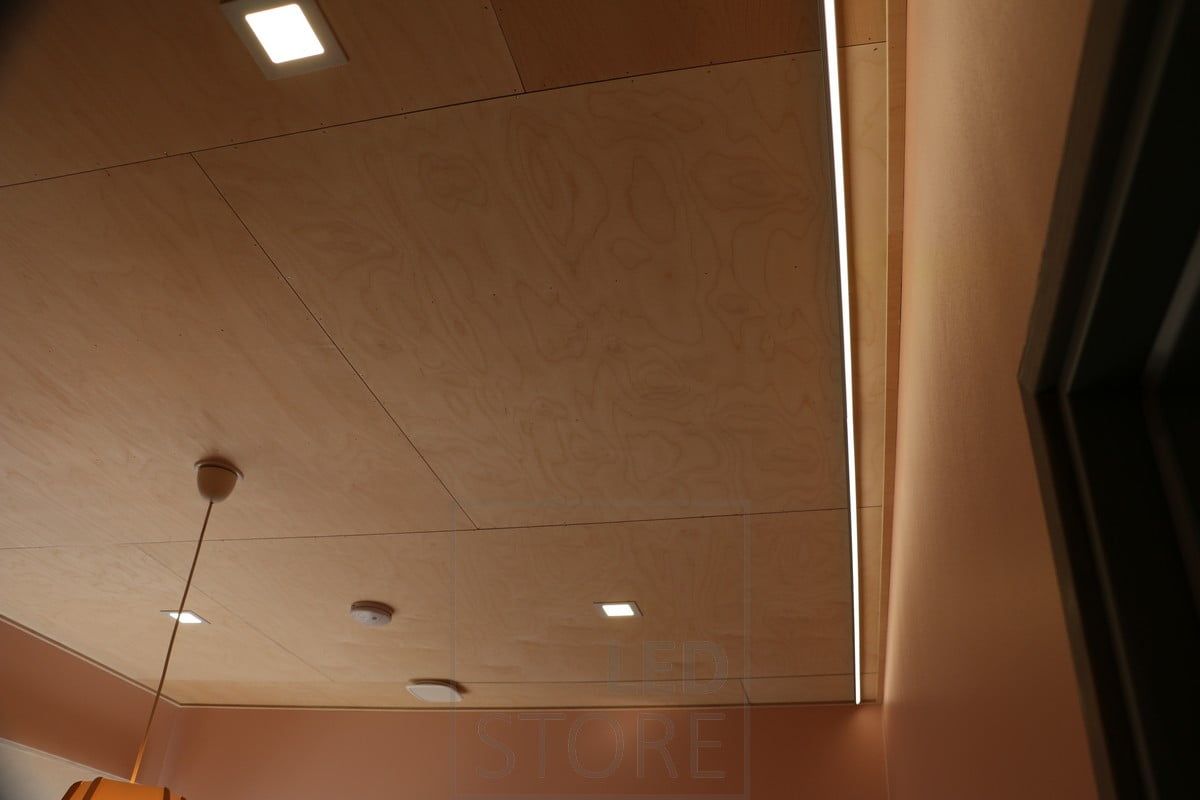 Panel lights and indirect light in the living room, with a decorative ceiling light in the middle of the room. Ledstore.fi