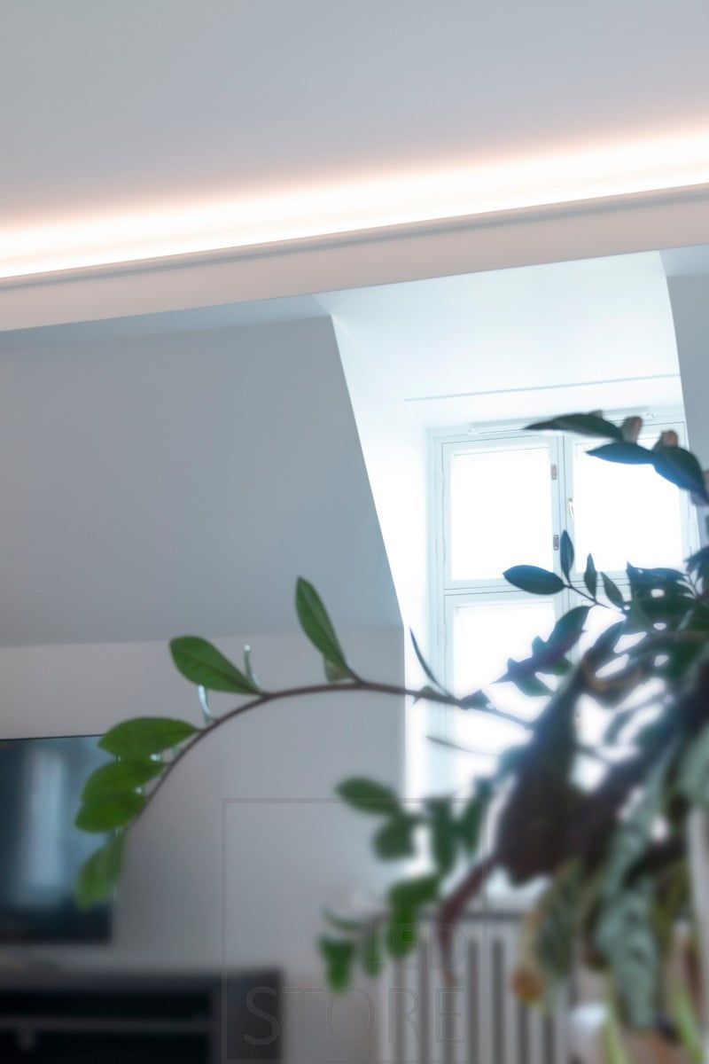 In the ceiling of a downstairs shed, an LED strip indirectly illuminates the living room, directed towards the ceiling and the front. Ledstore.fi
