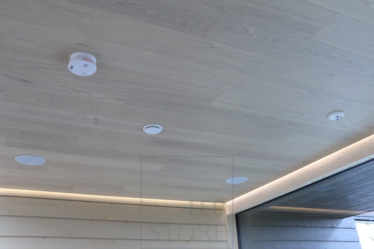 Between the ceiling and the wall, an LED strip illuminates the living room with indirect light. Ledstore.fi