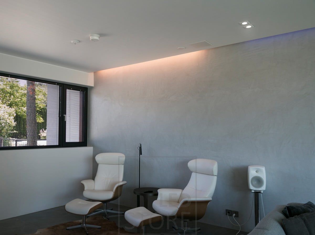 In the living room, indirect lighting between ceiling and wall combined with spotlights. Ledstore.fi