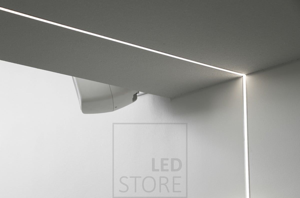 Led strip mounted on a flush-mounted profile, extending from the ceiling down the wall. Ledstore.fi