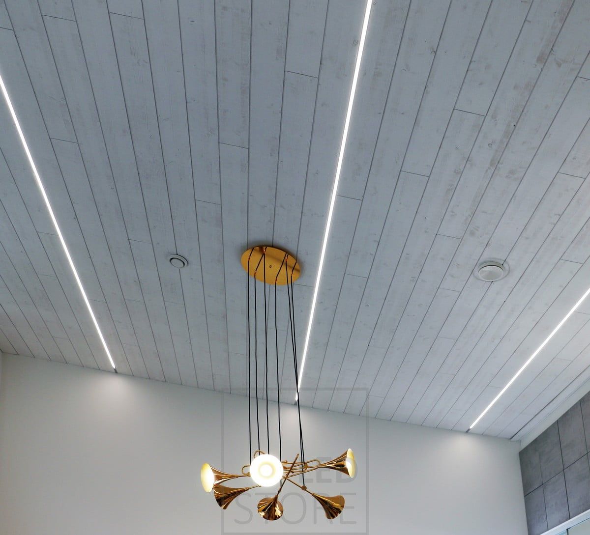 The ceiling has LED strips installed along the entire length of the space, creating a pleasant lighting and modern look. Ledstore.fi