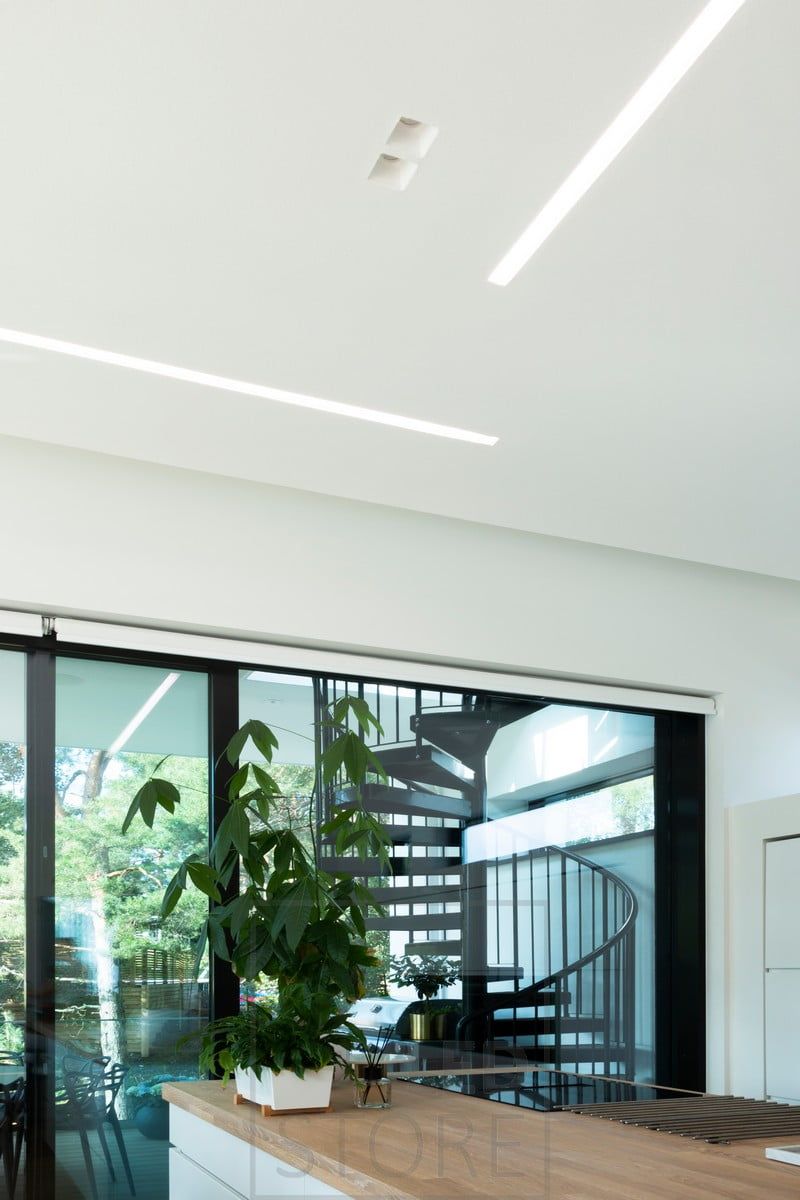 A wide uppo profile combined with spots to create general lighting in a large open plan living room. Ledstore.fi