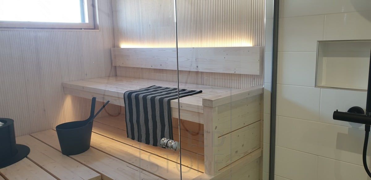 LED strip on the back of the sauna backrest illuminates atmospheric light upwards and downwards under the ceiling. Ledstore.fi