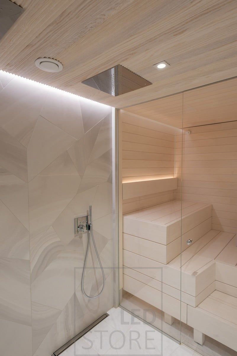 Atmospheric indirect lighting for the sauna and washroom. In the washroom, an LED strip in the groove between the ceiling and the wall, illuminates through the wall and highlights the beautiful tile. In the sauna, the led strip in the backrest is directed upwards. Ledstore.fi