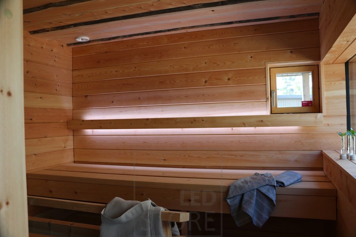 Sauna lighting implemented with led light strips on the backrest. Led strips illuminate upwards and downwards. Ledstore.fi