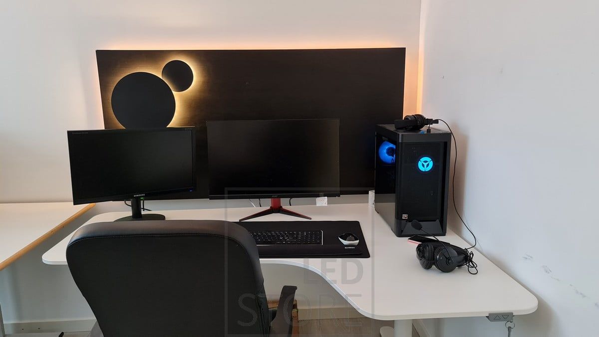 At the workstation, atmospheric light behind the computer. Two Eclipse wall lights mounted on a black plate. Ledstore.fi