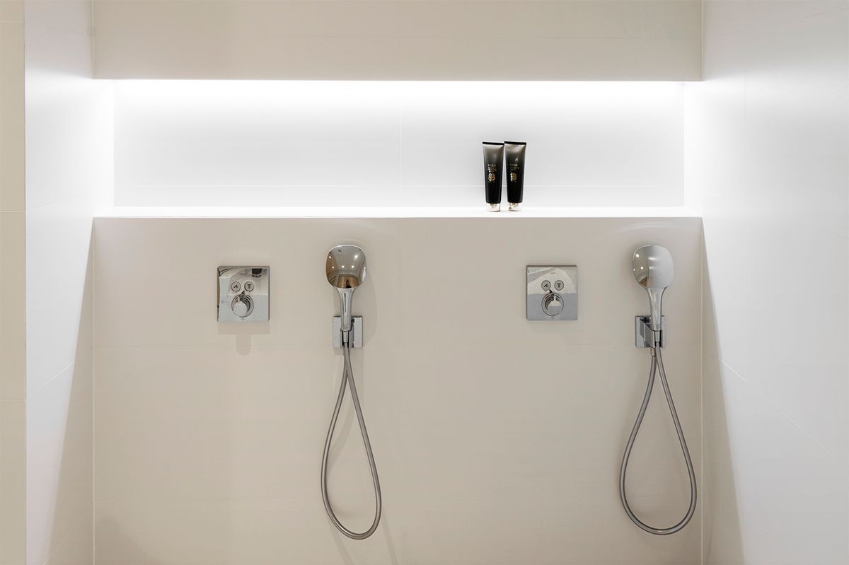 Shampoo shelf in the bathroom, in the upper corner of the shelf illuminated by a led strip. Ledstore.fi