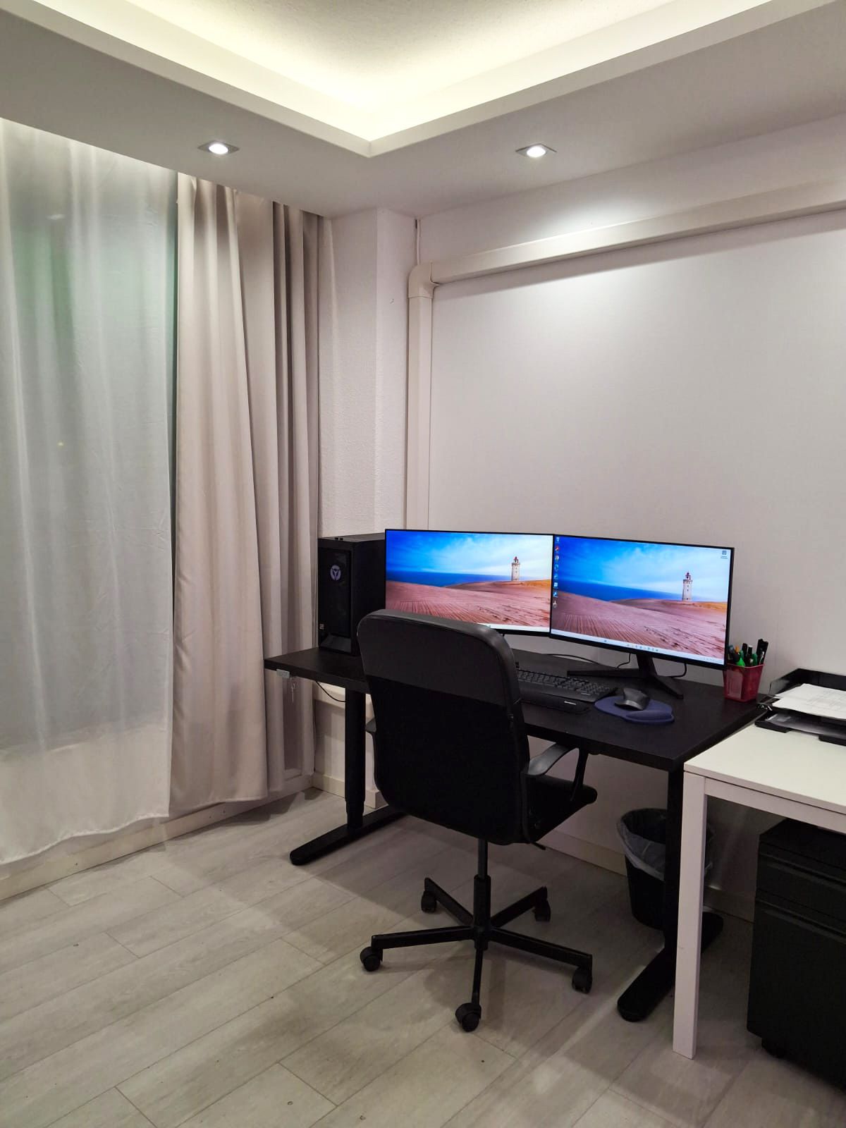 Study with computer desk and desk chair, drop ceiling. Spotlights and indirect light from led strips installed in the lower ceiling.