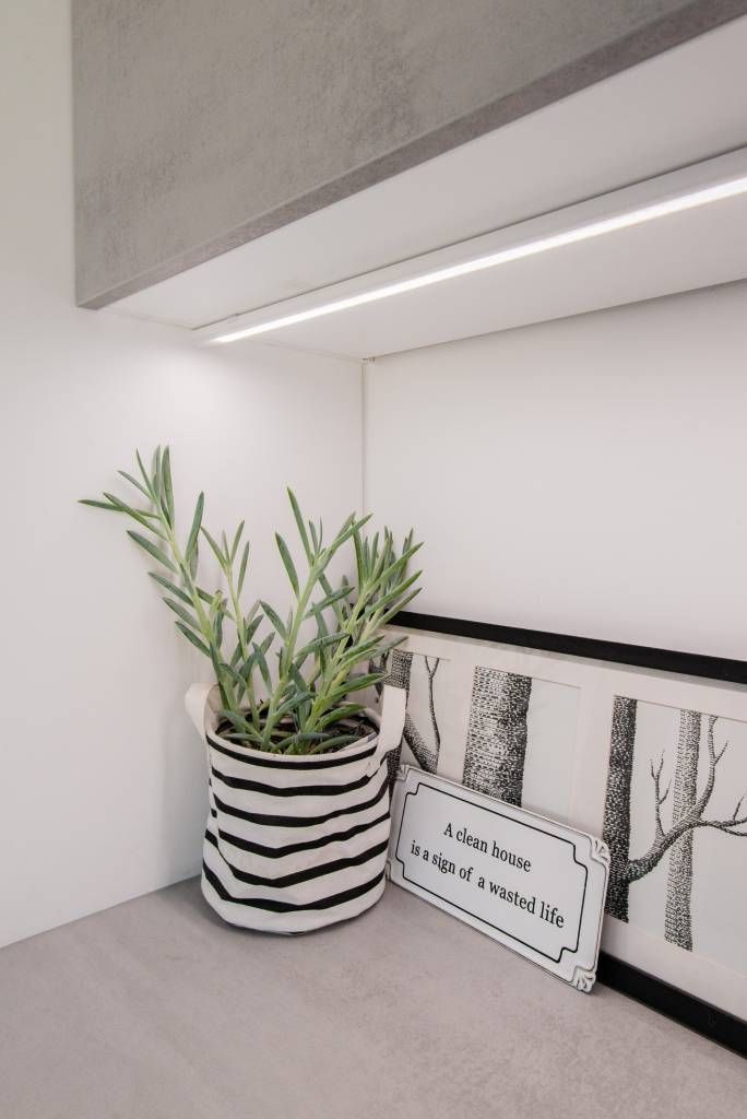 Minimalist design with "LED STORE" in a white square against a green background, highlighting energy efficient lighting solutions.