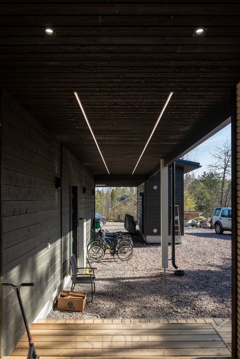 At the entrance, spots on the ceiling, in the canopy, LED strips illuminating the surface profile. Ledstore.fi