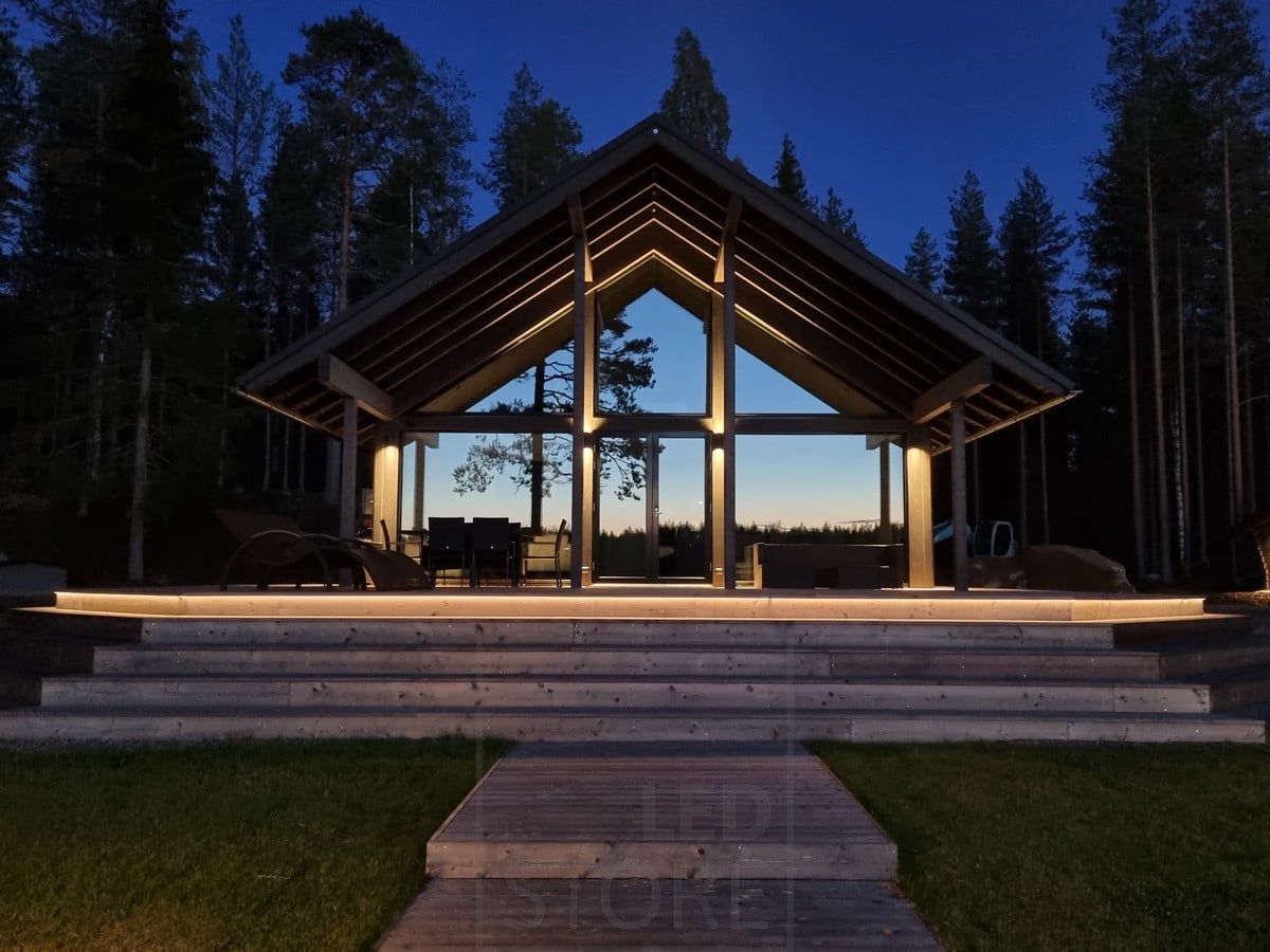 Versatile outdoor lighting realized with LED strip on the staircase and wall lights. Wall lights illuminating in two directions at a high point. Ledstore.fi