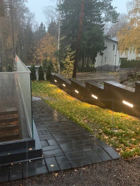 Led ribbon embedded in a wall creating atmospheric lighting in the courtyard. Ledstore.fi