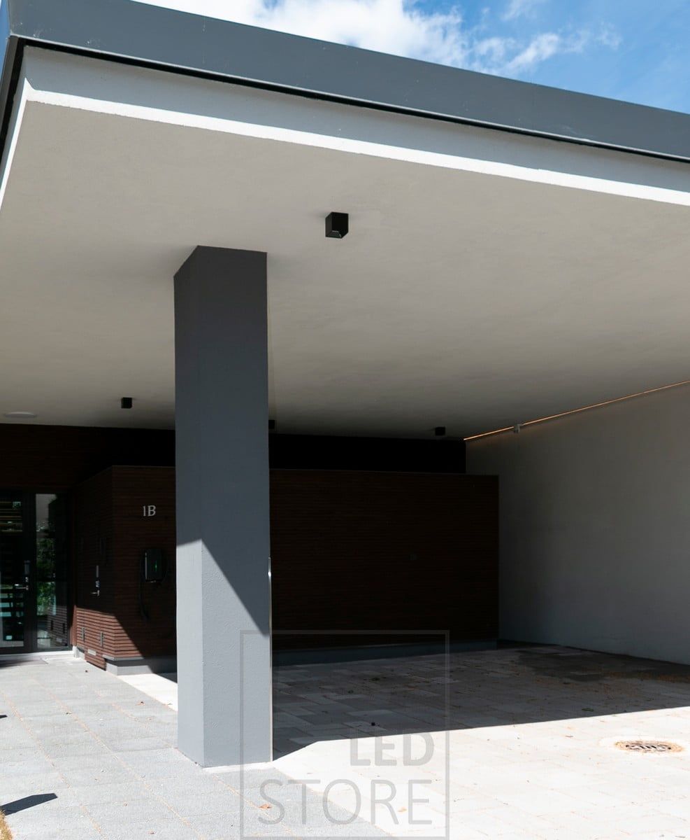 Exterior ceiling with surface spotlights and led strip next to the wall. Ledstore.fi
