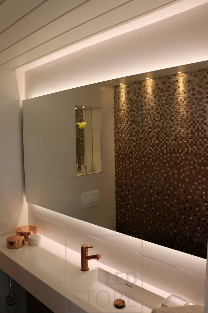 Behind a large mirror, LED strips indirectly illuminate. Ledstore.fi
