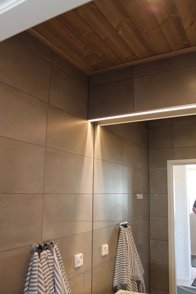 Mirror with LED strip illuminated in the toilet room. Ledstore.fi