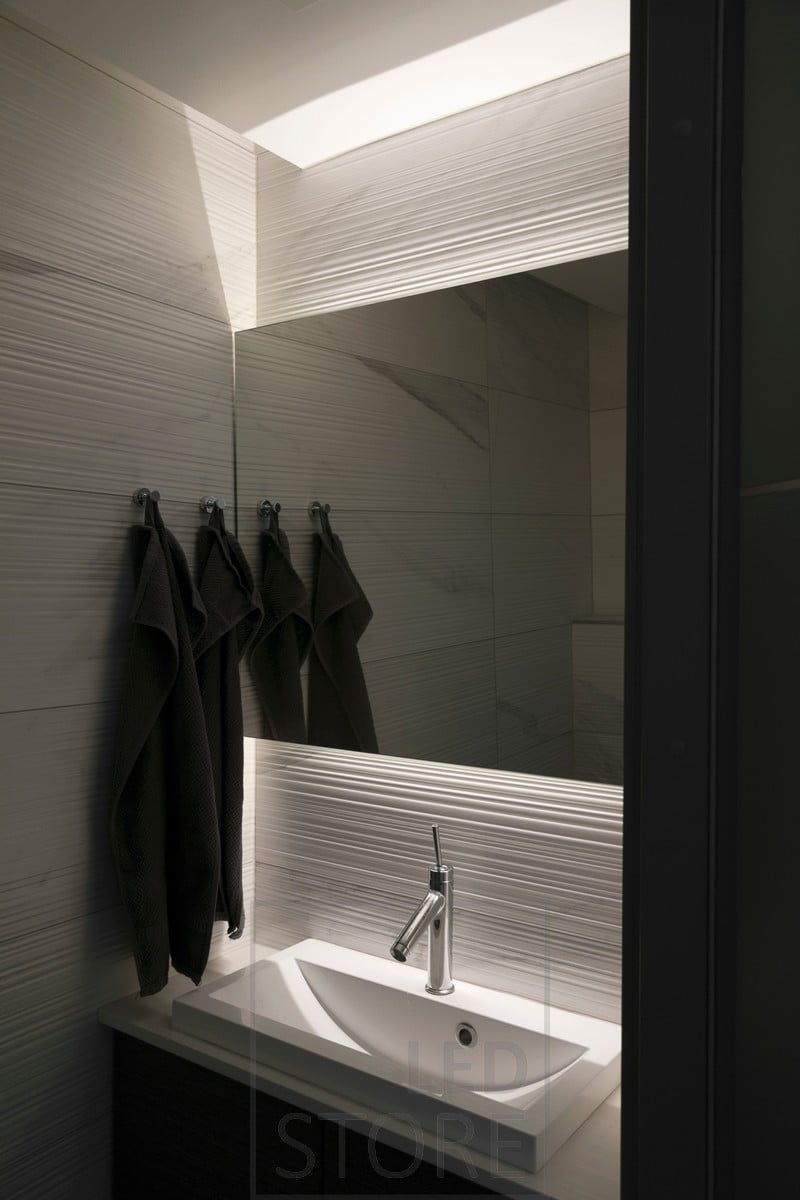 LED strip behind the mirror for mood lighting. The indirect lighting also highlights the beautiful tile. Ledstore.fi
