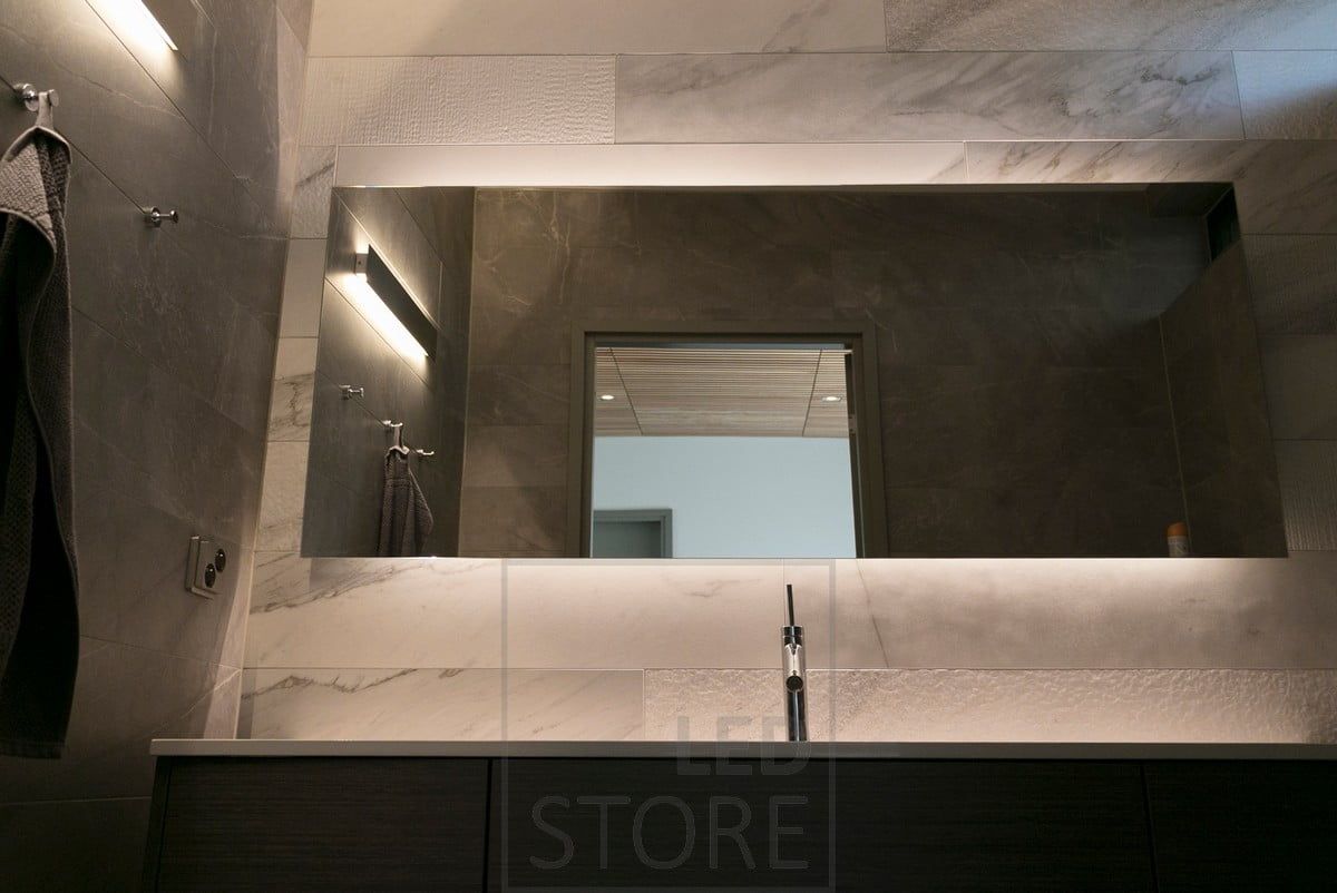 Behind a beautiful, large mirror, an LED strip highlights the mirror and creates mood lighting. In addition, a bi-directional wall light. Ledstore.fi