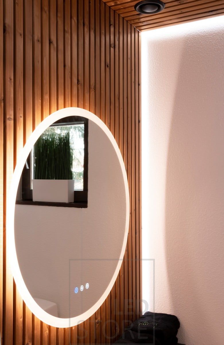 Light mirror illuminating through the wall to the sides, through the frost to the face, with additional indirect light behind the batten with led strip. Ledstore.fi