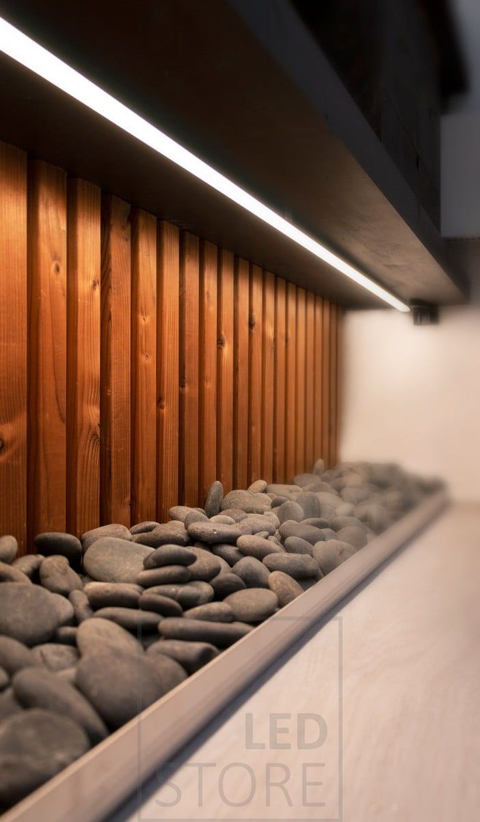 Below the level of the toilet, an LED strip in a low profile surface illuminates the decorative stones placed underneath. Ledstore.fi