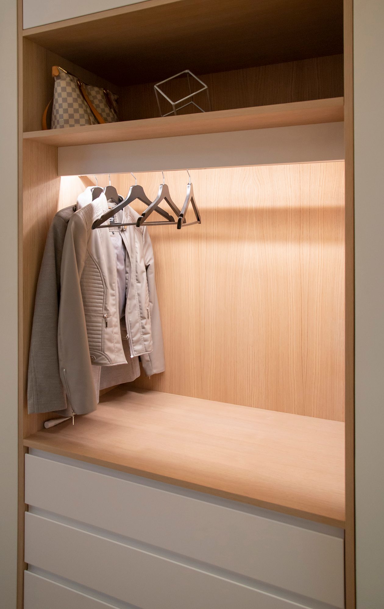 A wardrobe with a led strip light illuminating the contents of the wardrobe with indirect light. Ledstore.fi