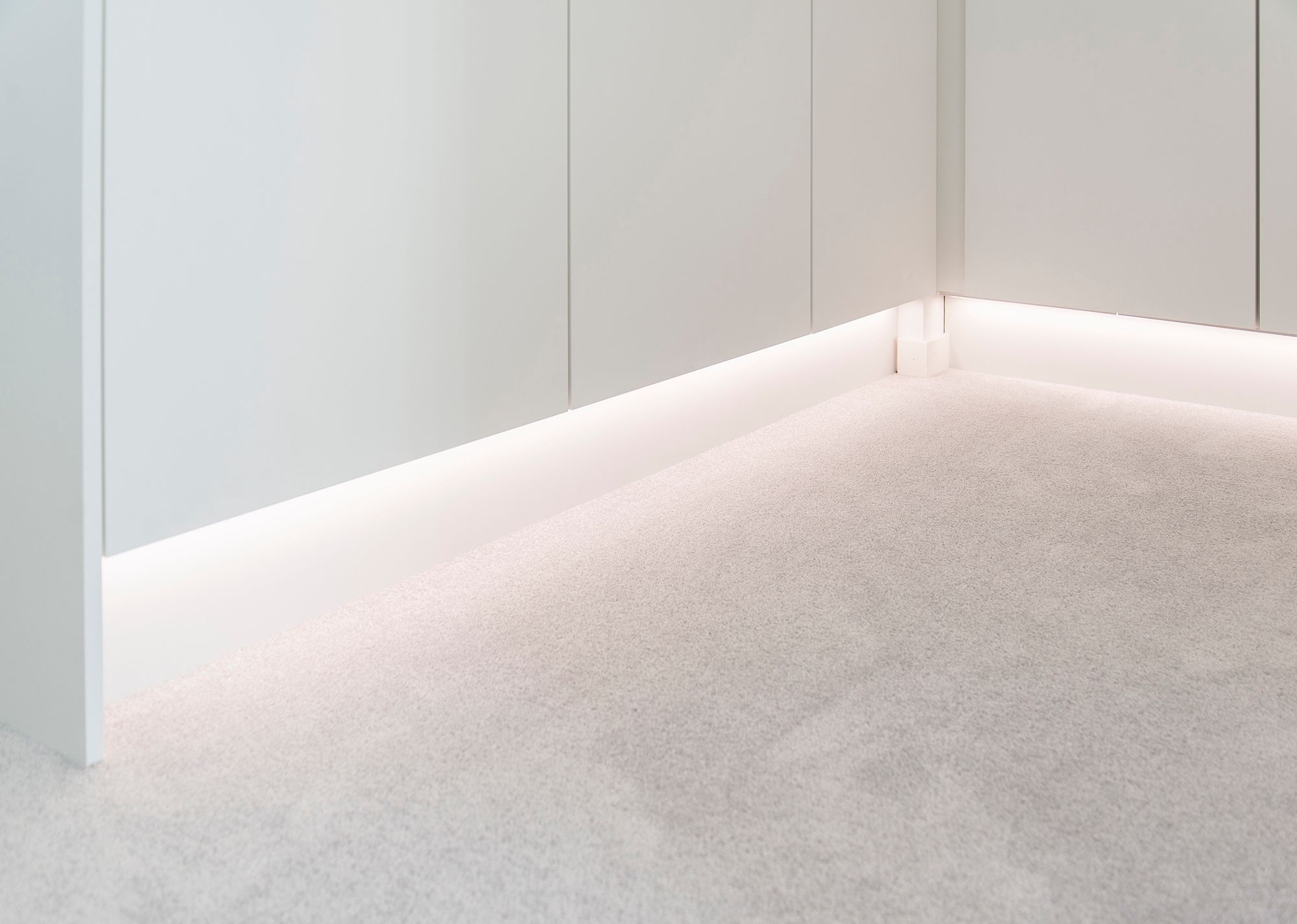 A LED strip light at the base of a wardrobe, illuminating indirect, atmospheric light. Light colour temperature 4000K Ledstore.fi