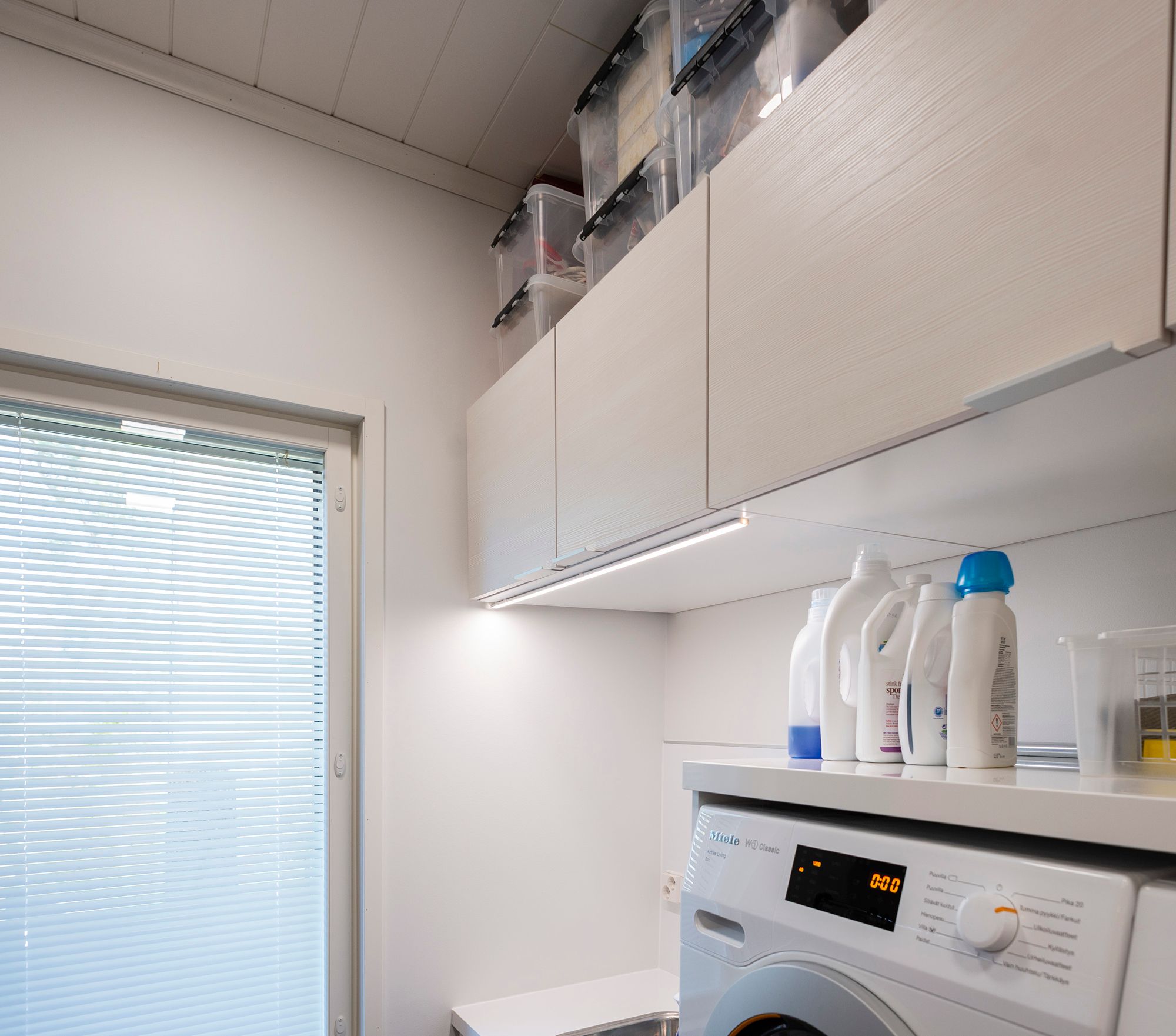 LED strip for extra light in the utility room, attached to the front edge of the cabinet. Ledstore.fi