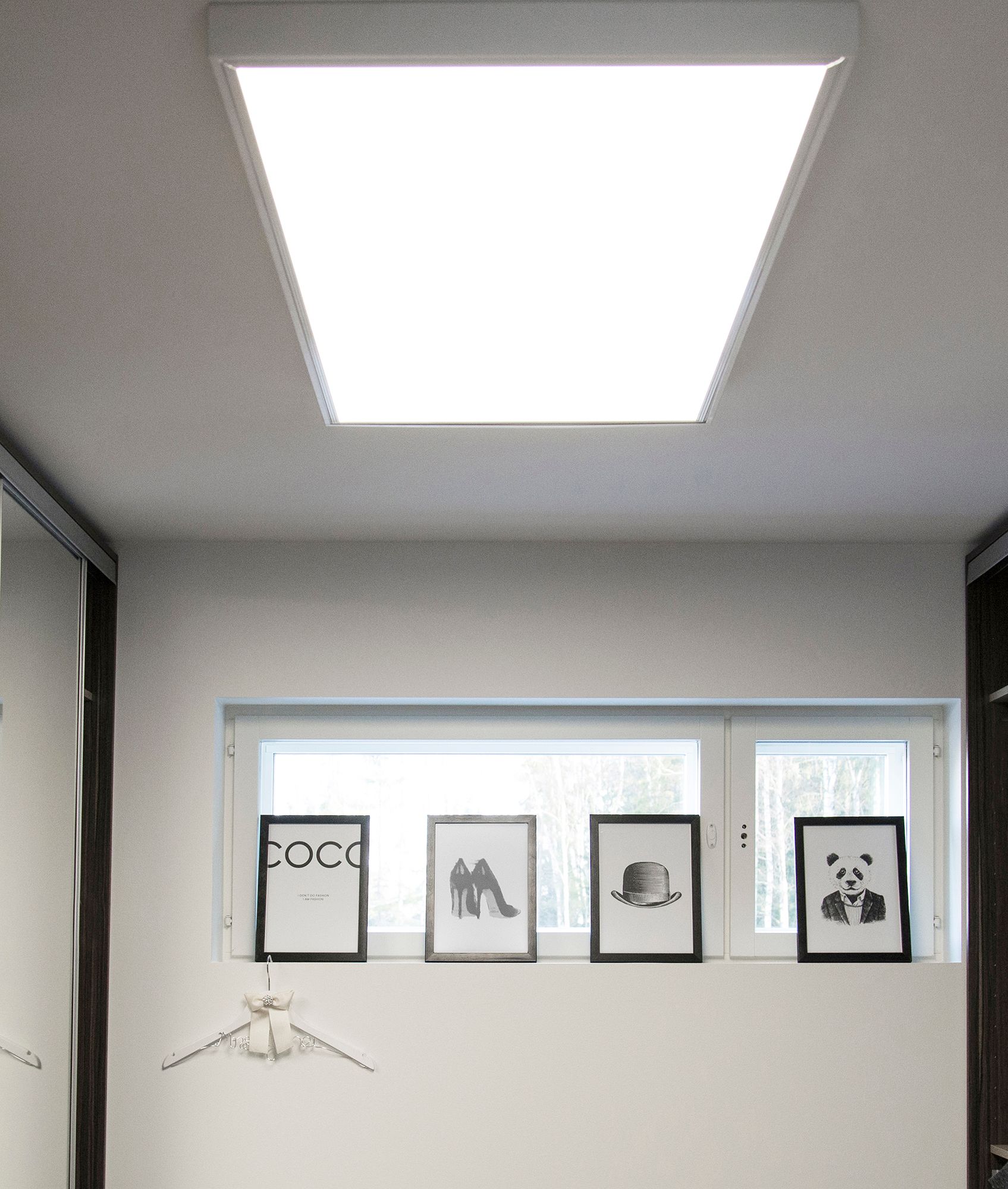 600x1200 panel on the ceiling of a hallway in a surface frame. The large luminaire resembles a skylight and illuminates the space evenly and efficiently. Ledstore.fi