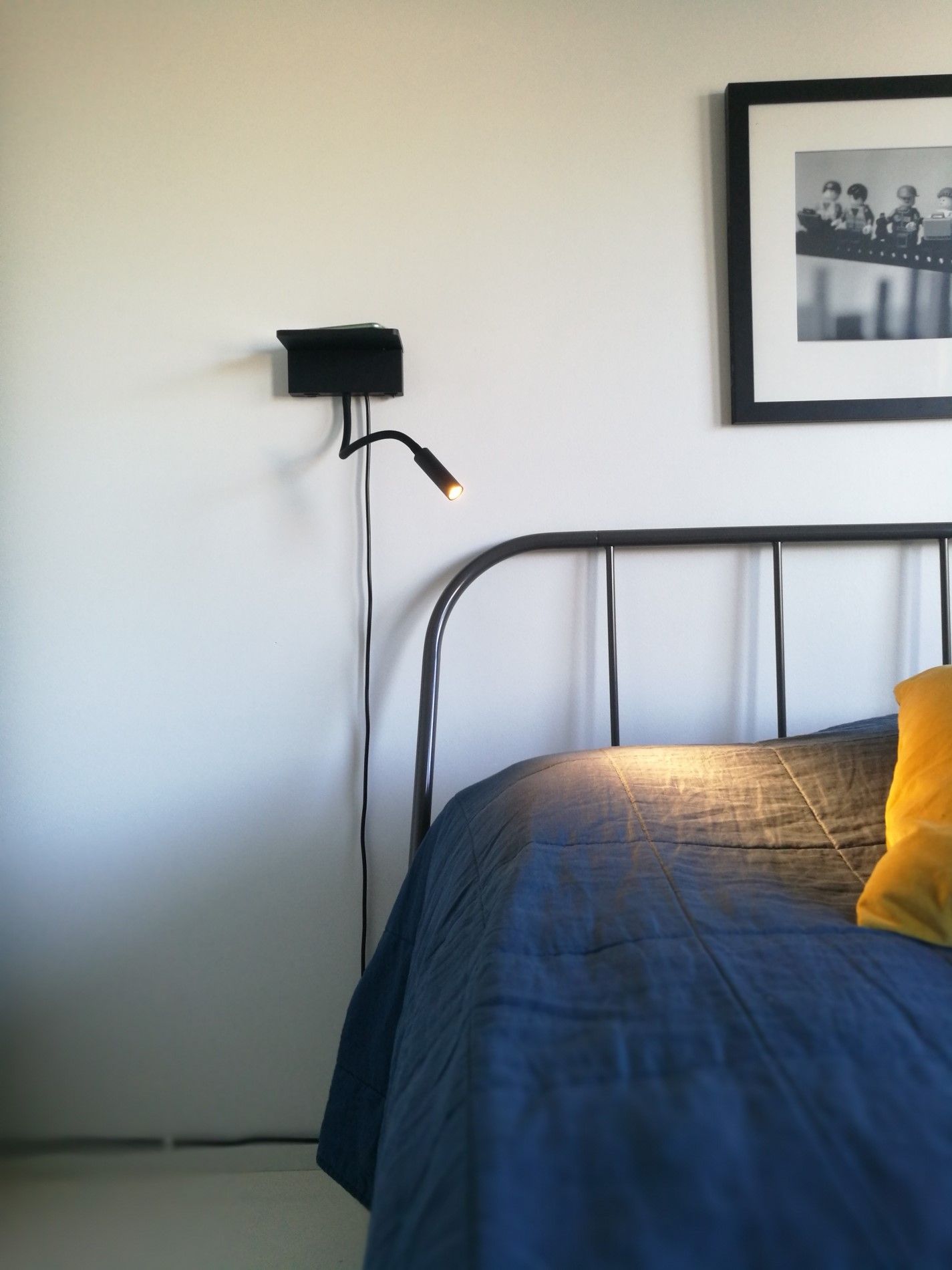 NIGHT BLADE lamp on the wall next to the bed, illuminated