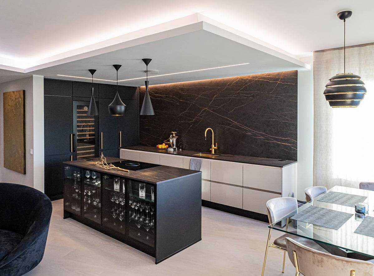 Led strip lighting wraps around the edges of the kitchen's lowered ceiling.