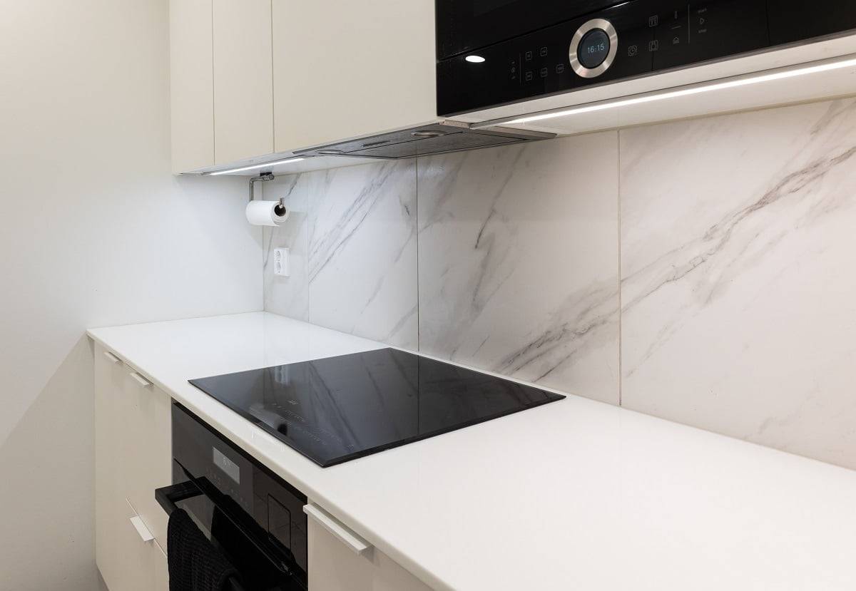 Countertop lighting with LED strip profile mounted on the bottom of kitchen cabinets