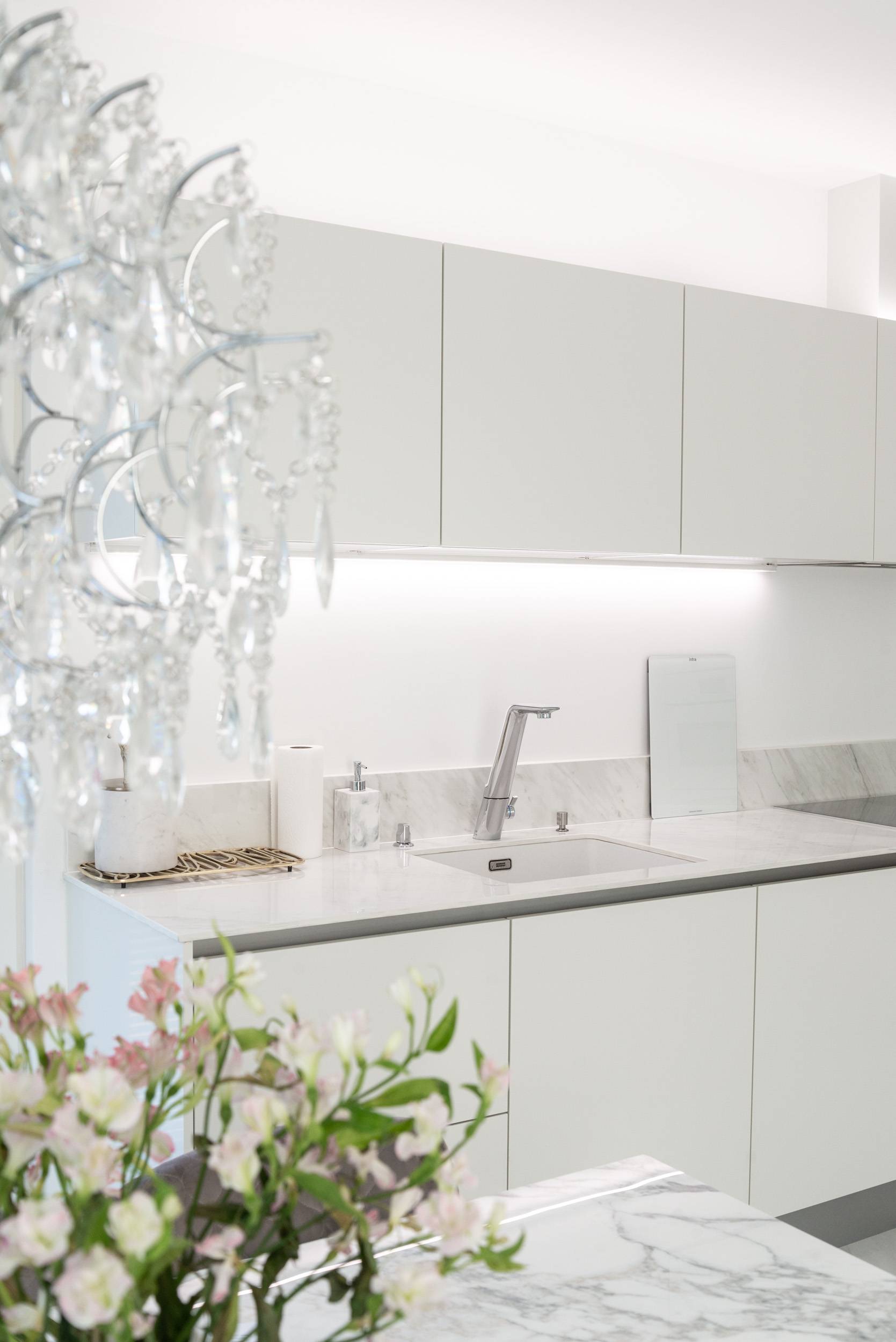 LED strips above the kitchen cabinets and beneath the countertop.