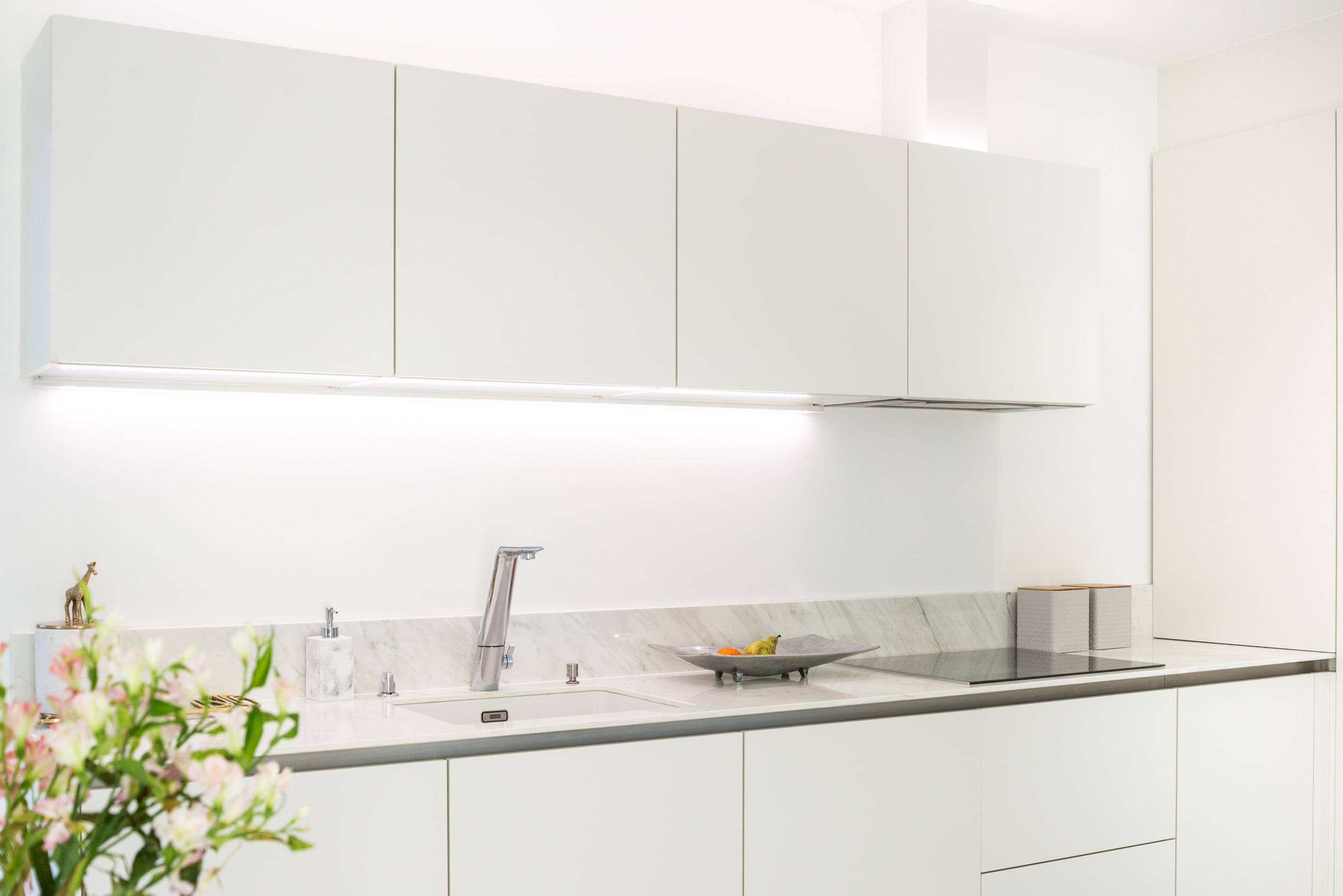 LED profile installed under the top cabinet in kitchen and it illuminates the kitchen countertop
