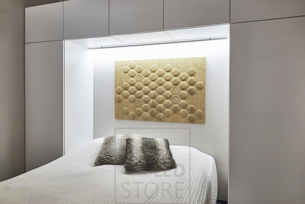 In the bedroom, an LED strip mounted behind the bed, at the base of the wall cupboard, provides atmospheric indirect light. Ledstore.fi