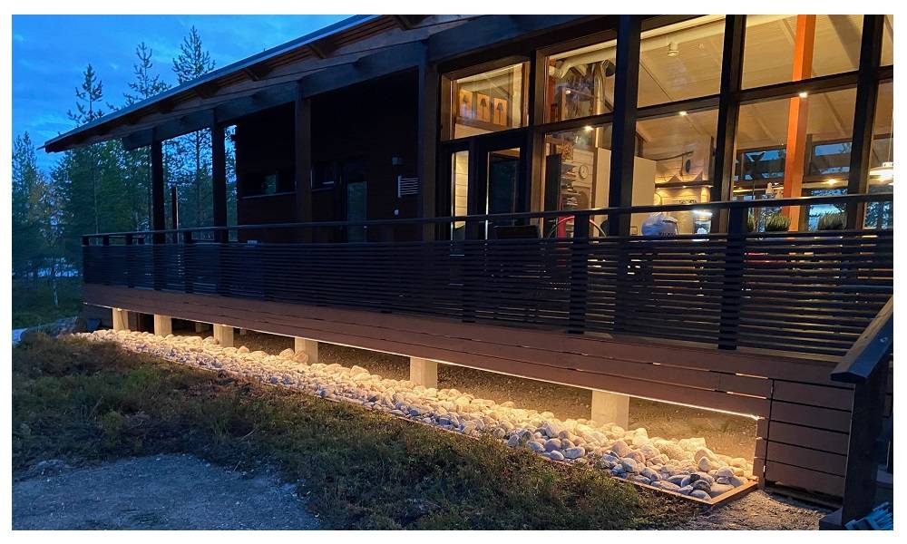 An illuminated LED strip in the terrace base at dusk.