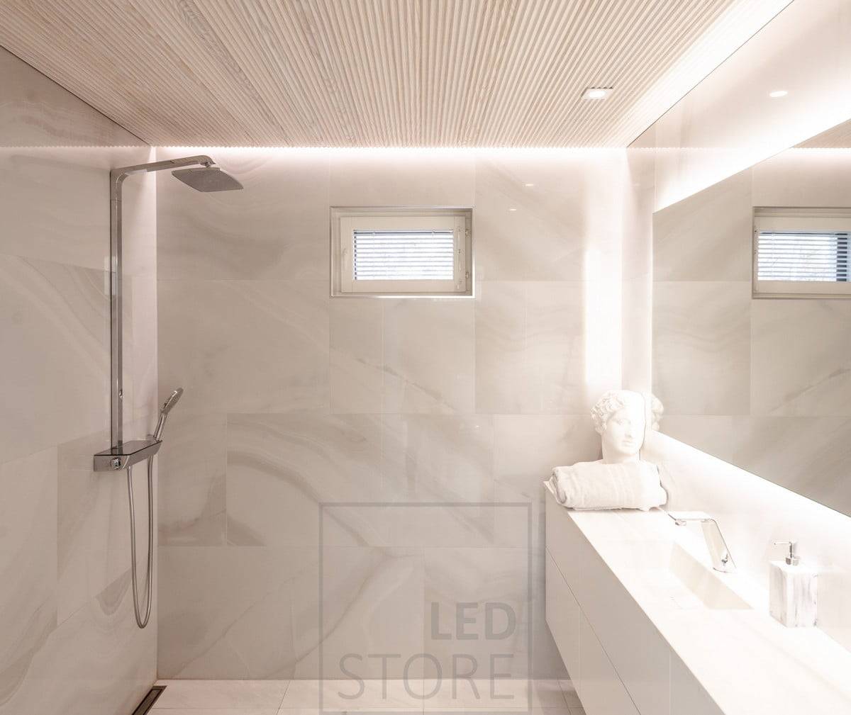 The bathroom has versatile and atmospheric lighting. HALO 1200 as a light mirror and CHEAP KANTTI led spots on the level illuminating the face from above. Led strip installed in the groove between ceiling and wall to illuminate the space with indirect mood lighting through the wall. Ledstore.fi  